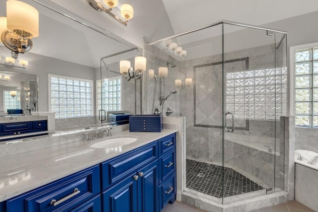 full bath with a bath, a stall shower, a wealth of natural light, and vanity