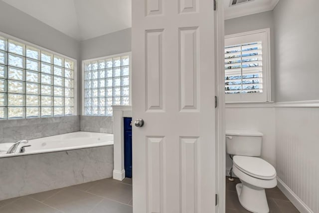 full bath with toilet, visible vents, a bath, and tile patterned floors