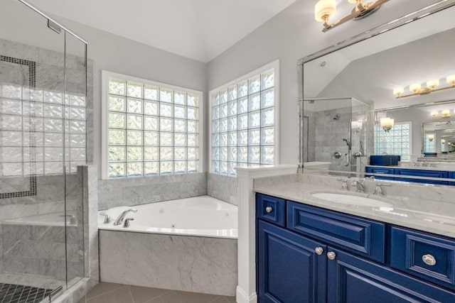 bathroom with vaulted ceiling, a shower stall, vanity, a bath, and tile patterned floors