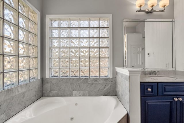 bathroom with a jetted tub and vanity