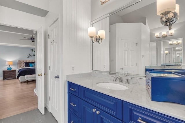 ensuite bathroom with tile patterned flooring, vanity, a ceiling fan, and ensuite bathroom