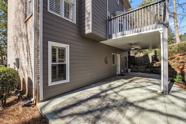 view of patio / terrace with ceiling fan and a balcony