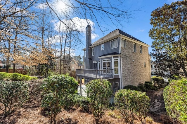 rear view of house featuring a chimney