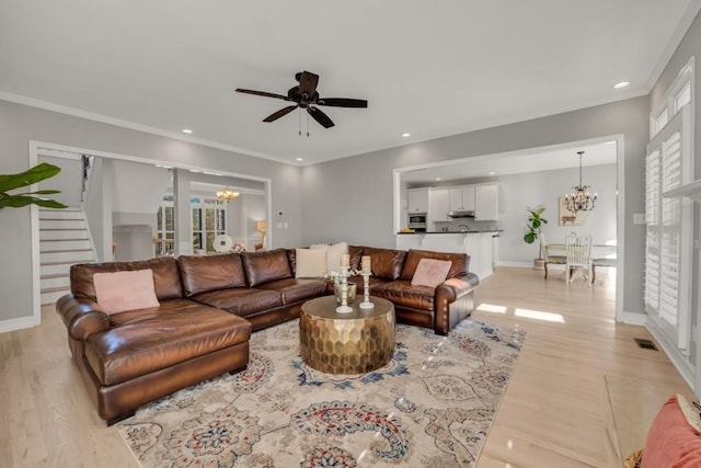 living area featuring baseboards, stairway, ornamental molding, light wood-style floors, and recessed lighting