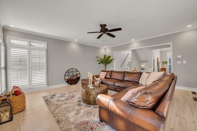 living area with recessed lighting, wood finished floors, baseboards, stairs, and ornamental molding