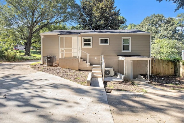 rear view of house with ac unit and central AC unit