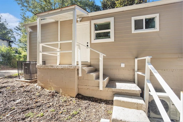 rear view of property with ac unit