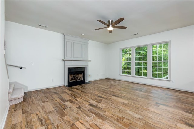 3260 Ridgefair Dr, Cumming, GA 30040 - unfurnished living room with light wood-type flooring, a ceiling fan, a fireplace, baseboards, and stairway