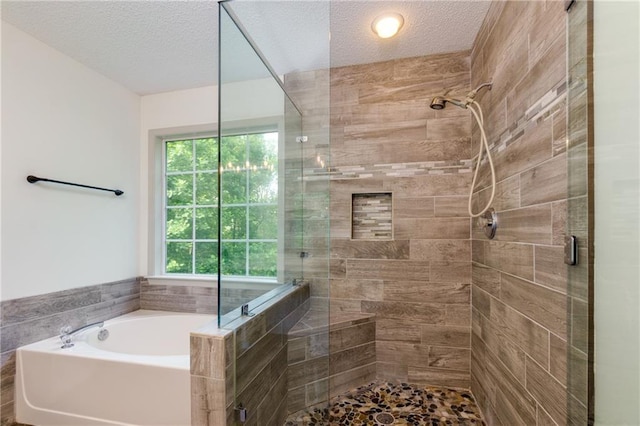 3260 Ridgefair Dr, Cumming, GA 30040 - bathroom featuring a shower stall, a textured ceiling, and a garden tub