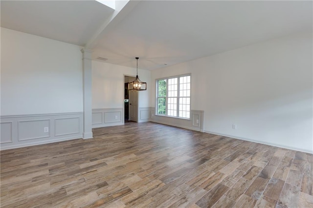 3260 Ridgefair Dr, Cumming, GA 30040 - spare room featuring a chandelier, wood finished floors, wainscoting, and a decorative wall