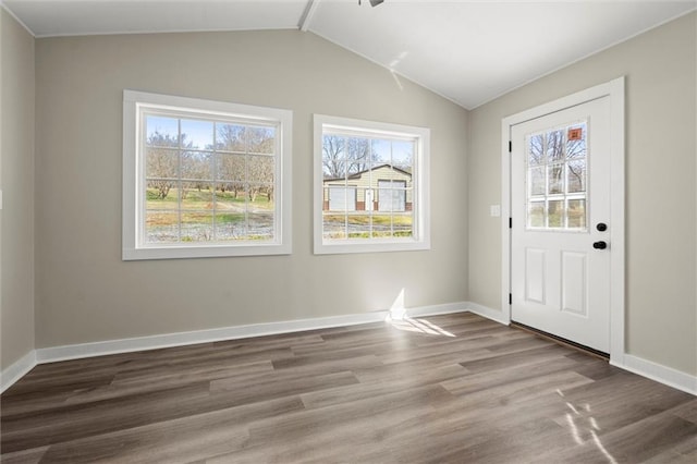 entryway featuring vaulted ceiling, wood finished floors, and baseboards