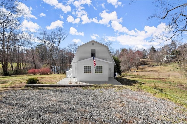 view of property exterior featuring a gambrel roof