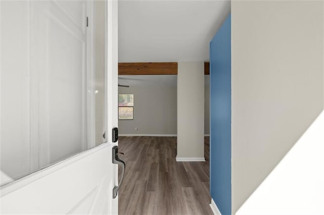 hallway with baseboards and wood finished floors