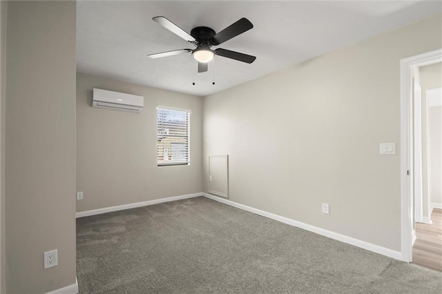 spare room with ceiling fan, carpet, a wall mounted AC, and baseboards