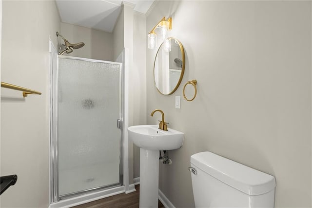 full bathroom with a sink, toilet, wood finished floors, and a shower stall