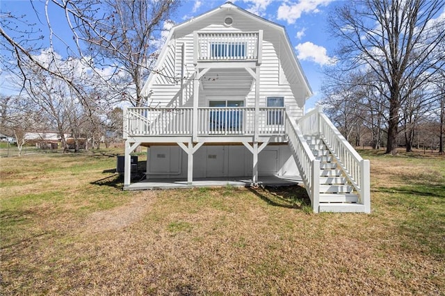 back of house with a gambrel roof, a yard, stairway, a wooden deck, and a patio area