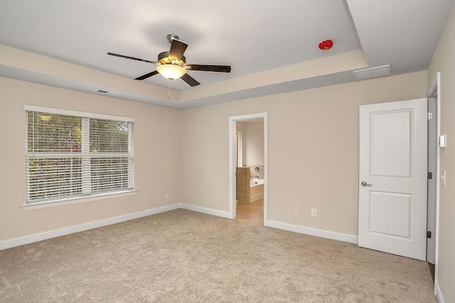 201 Cooper Dr, Mansfield, GA 30055 - unfurnished bedroom with baseboards, light colored carpet, a raised ceiling, and ensuite bathroom