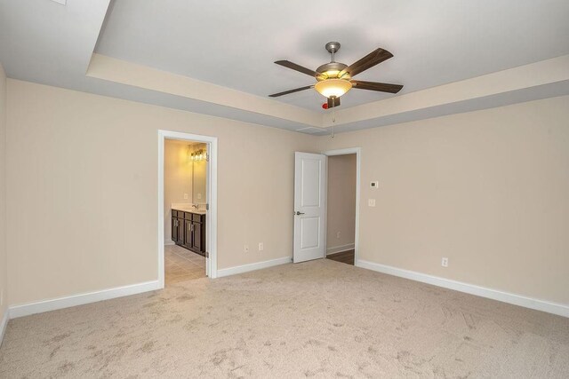 201 Cooper Dr, Mansfield, GA 30055 - unfurnished bedroom with light carpet, baseboards, a raised ceiling, and ensuite bath