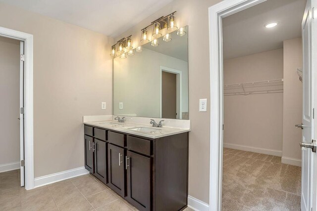 201 Cooper Dr, Mansfield, GA 30055 - bathroom featuring double vanity, baseboards, and a spacious closet