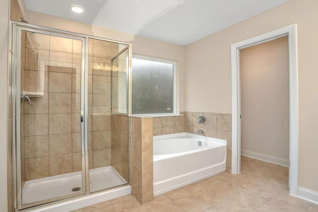 201 Cooper Dr, Mansfield, GA 30055 - bathroom featuring a garden tub, a stall shower, tile patterned flooring, and recessed lighting