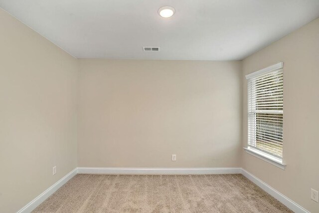 201 Cooper Dr, Mansfield, GA 30055 - empty room featuring baseboards, light carpet, and healthy amount of natural light
