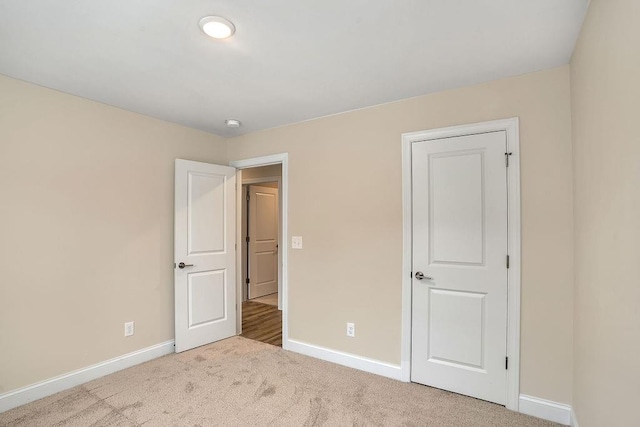 unfurnished bedroom with light carpet