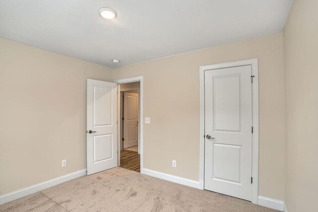 201 Cooper Dr, Mansfield, GA 30055 - unfurnished bedroom with baseboards and carpet floors