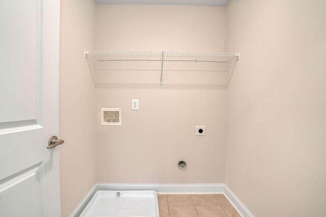 201 Cooper Dr, Mansfield, GA 30055 - laundry area featuring electric dryer hookup, washer hookup, light tile patterned flooring, and baseboards