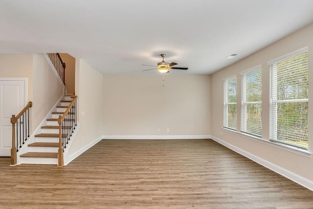 unfurnished room with ceiling fan, a healthy amount of sunlight, and light wood-type flooring