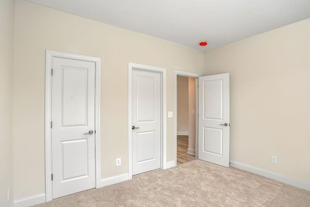 unfurnished bedroom featuring light colored carpet