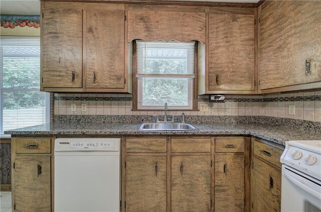 kitchen featuring sink, white appliances, and a textured ceiling