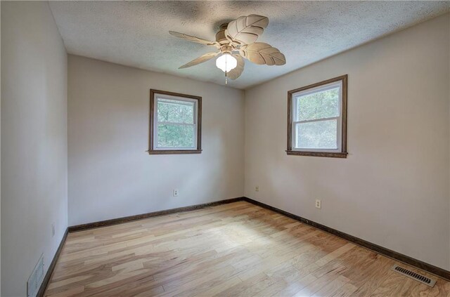 unfurnished bedroom featuring light hardwood / wood-style floors, a textured ceiling, and a closet