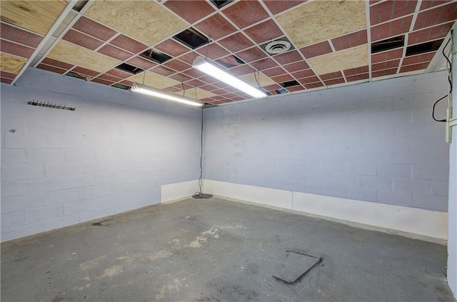 interior space with concrete block wall and visible vents