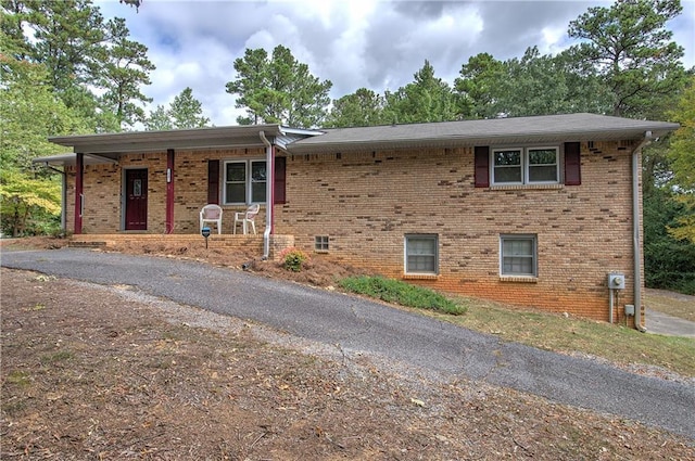 view of front of house with covered porch and brick siding