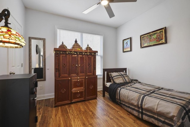 bedroom with dark wood-style floors and baseboards