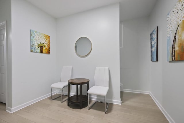 sitting room with light wood-style flooring and baseboards