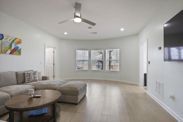 living room with recessed lighting, visible vents, and light wood-style floors