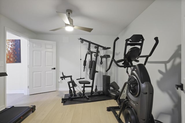 workout area with ceiling fan, baseboards, and wood finished floors