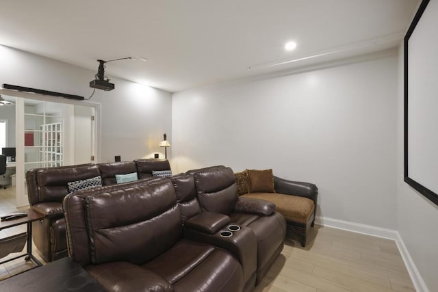 home theater featuring light wood finished floors, recessed lighting, and baseboards