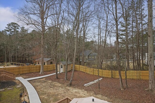 view of yard featuring an outdoor structure and fence private yard