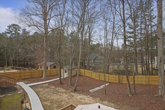 view of yard with fence private yard and an outbuilding