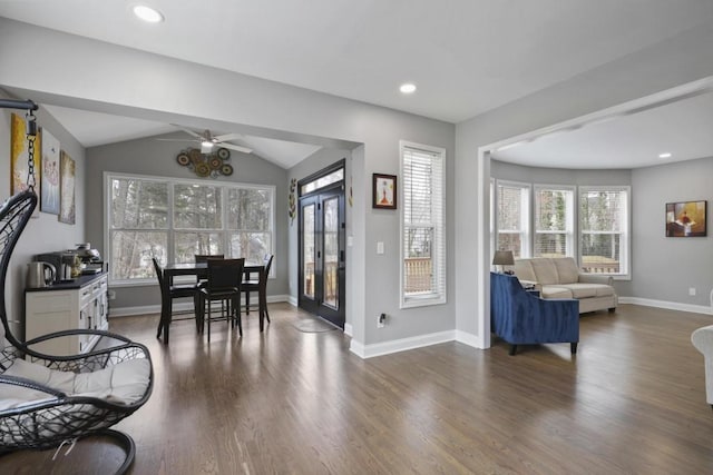 dining room featuring lofted ceiling, dark wood finished floors, and a wealth of natural light