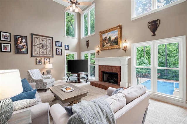 206 Kingsley Way, Woodstock, GA 30188 - living area with carpet flooring, a towering ceiling, plenty of natural light, ceiling fan, and a fireplace
