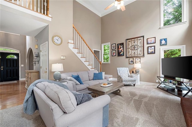 206 Kingsley Way, Woodstock, GA 30188 - living area with a towering ceiling, arched walkways, plenty of natural light, a ceiling fan, and baseboards