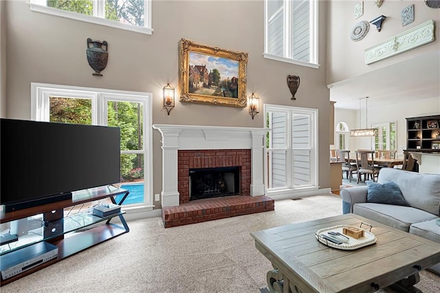 206 Kingsley Way, Woodstock, GA 30188 - carpeted living area with a towering ceiling, healthy amount of natural light, and a fireplace