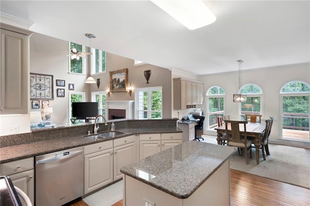 206 Kingsley Way, Woodstock, GA 30188 - kitchen with stainless steel dishwasher, a sink, a ceiling fan, a fireplace, and plenty of natural light