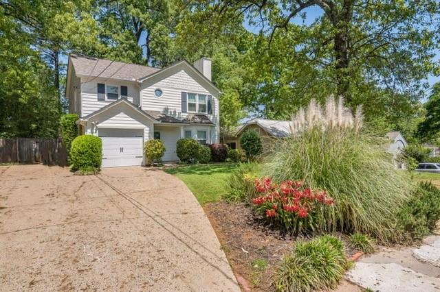 1123 Seaboard Ave NW, Atlanta, GA 30318 - view of front of property featuring driveway, fence, and a chimney
