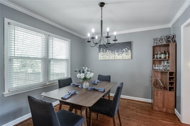 1123 Seaboard Ave NW, Atlanta, GA 30318 - dining room with baseboards, crown molding, wood finished floors, and a notable chandelier
