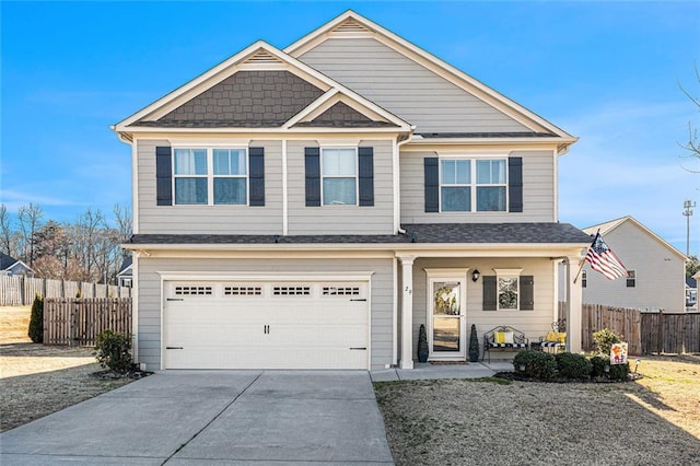 view of front of property featuring an attached garage, covered porch, fence, and concrete driveway