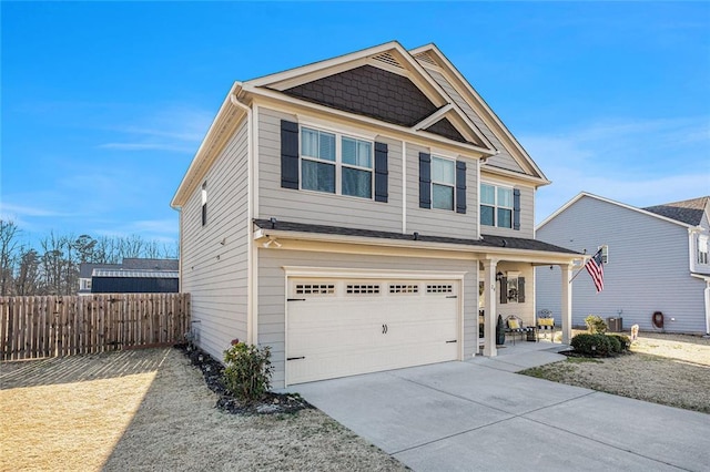 craftsman-style house featuring driveway, a garage, and fence